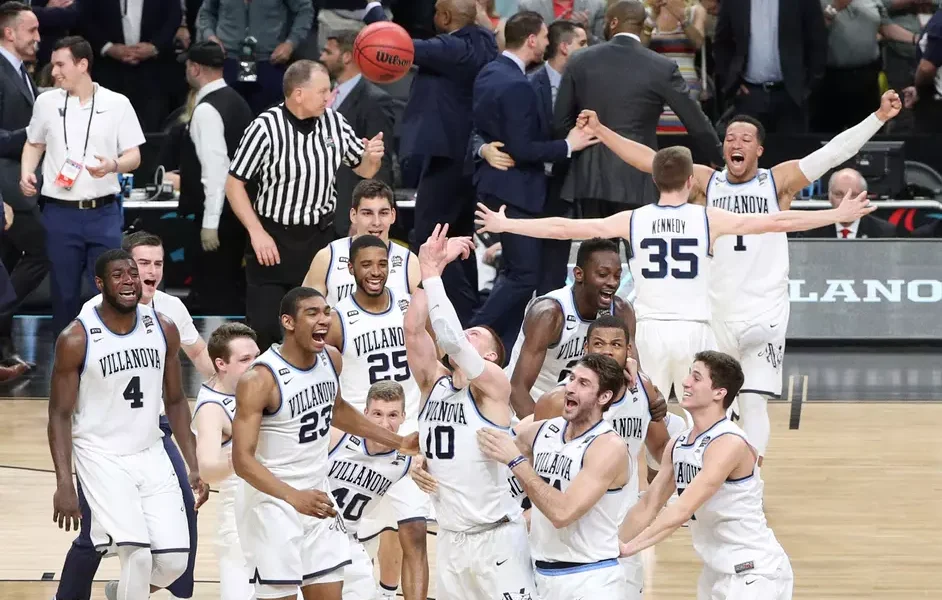 Villanova alumnus Donte DiVincenzo celebrates with his teammates after winning the 2018 NCAA championship. Image courtesy of Villanova athletics.
