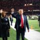 President Donald J. Trump and First Lady Melania Trump wave as they depart the field during the College Football Playoff National Championship between Clemson University and Louisiana State University Monday, Jan. 13, 2020, at the Mercedes-Benz Superdome in New Orleans. (Official White House Photo by Andrea Hanks)