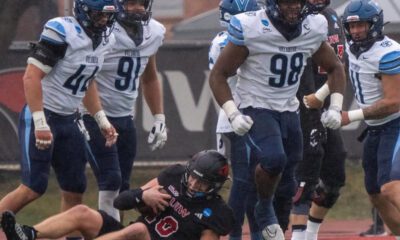Villanova Football defensive tackle Obinna Nwobodo (98) flexes after a tackle. Image courtesy of Obinna Nwobodo's Instagram account.